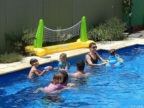 family swimming in a pool